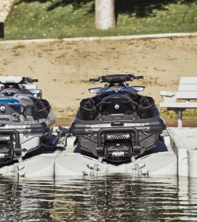 Jet skis docked on the water