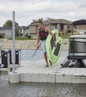 Man carrying paddle board