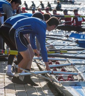 Rowers standing on a low profile dock