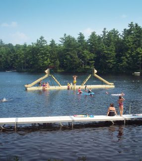 Floating docks with slide at a camp