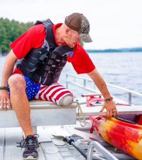 Man getting into Kayak launch
