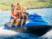Parents and child on blue jet ski