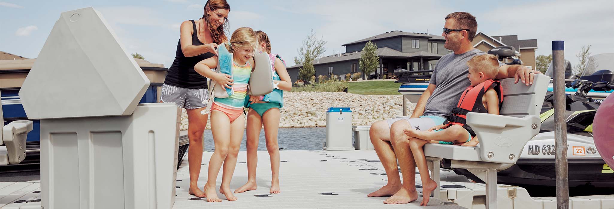 Family preparing for water activity on dock