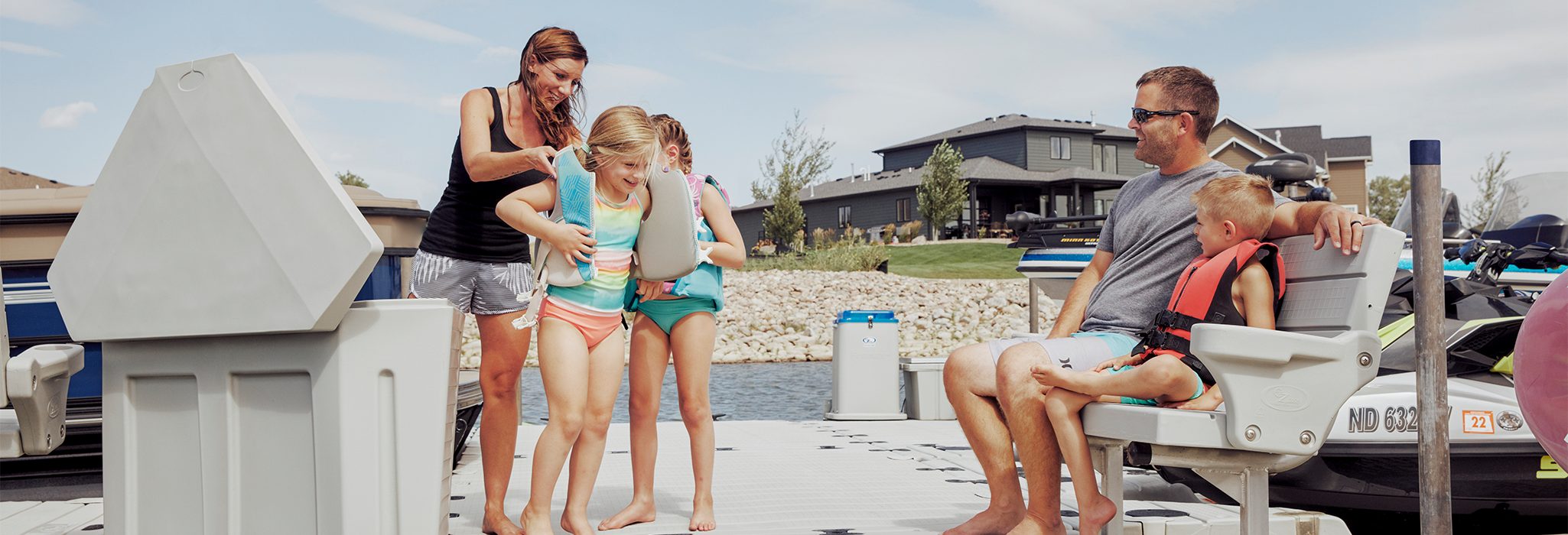 Family preparing for water activity on dock